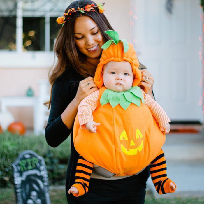 baby in a cute pumpkin costume